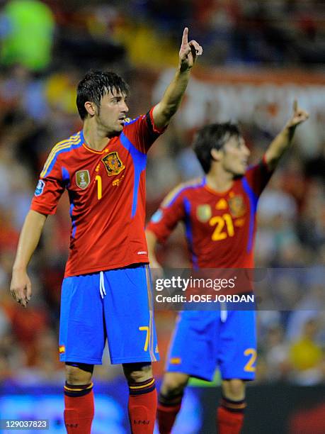 Spain's forward David Villa and Spain's forward David Silva react during the Euro 2012 qualifying football match between Spain and Scotland at the...