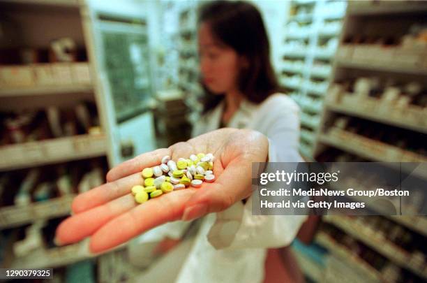 Pharmacist holds up the drug OxyContin at a local pharmacy.