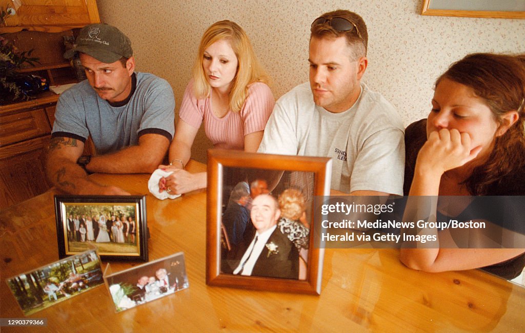 (08/01/2001- Plymouth MA) Son's and daughters of Philip McCloskey who was killed by serial killer Gary Sampson (L-R) Scott, Cheryl, Kevin and Charlene McCloskey mourn the death of their father who is shown in a bunch of family photos. (080101mcclos