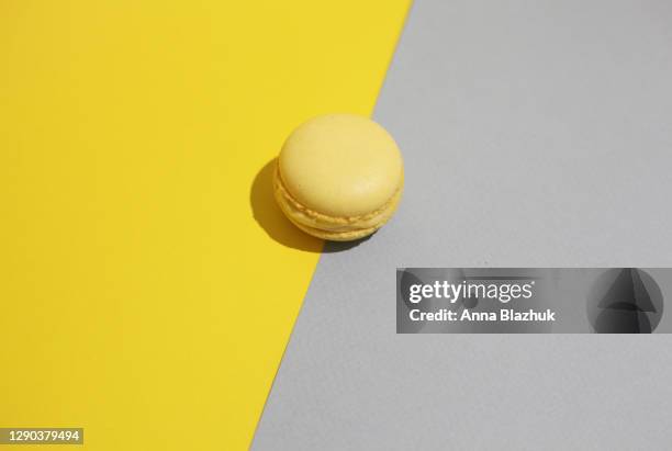 trendy colors of 2021 year, macaron cookie and ultimate gray and illuminating yellow, abstract background - macaron photos et images de collection