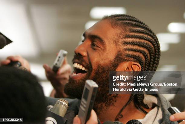 New England Patriots Randy Moss reacts to reporters questions surrounding the reports of a restraining order being sought by a female friend of his...