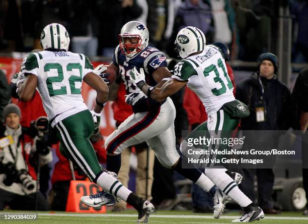 New England Patriots tight end Alge Crumpler takes a reception down the sideline against New York Jets safety Brodney Pool and New York Jets...