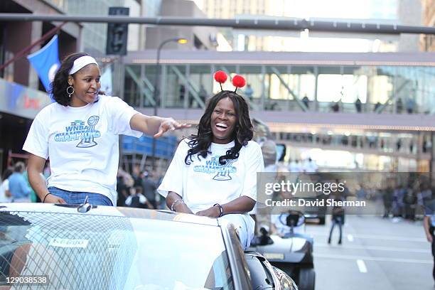 Maya Moor and Taj McWilliams-Franklin of the 2011 WNBA Champions Minnesota Lynx enjoy the crowd during the Minnesota Lynx Championship Parade through...