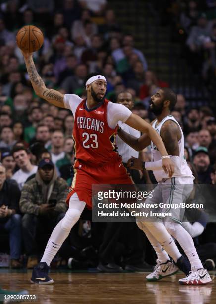New Orleans Pelicans forward Anthony Davis keeps the ball from Boston Celtics guard Kyrie Irving in the fourth quarter of the Boston Celtics vs. New...