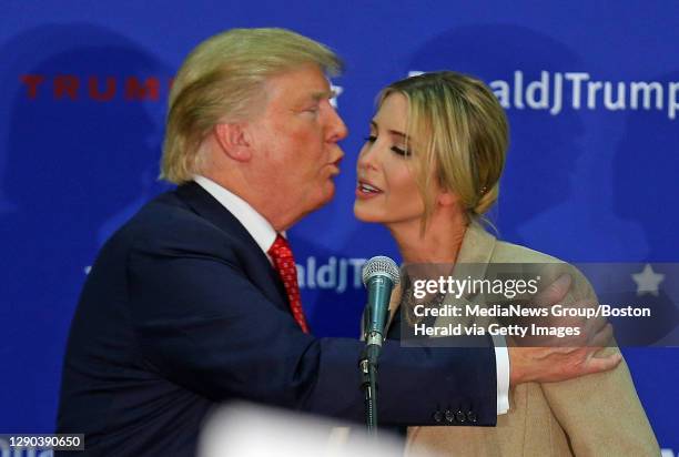 Republican candidate for President Donald Trump kisses his daughter Ivanka as he calls her up on stage during an event in Concord, NH on Monday,...