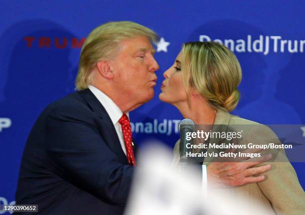 Republican candidate for President Donald Trump kisses his daughter Ivanka as he calls her up on stage during an event in Concord, NH on Monday,J...