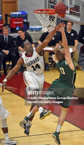 Harvard's Steve Moundou-Missi attempts to block this shot against Dartmouth's Tommy Carpenter closes in during 1st half action at Lavietes Pavilion...