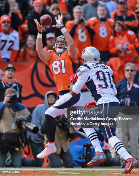 Denver Broncos tight end Owen Daniels hauls in a second quarter touchdown pass defended by New England Patriots outside linebacker Jamie Collins in...