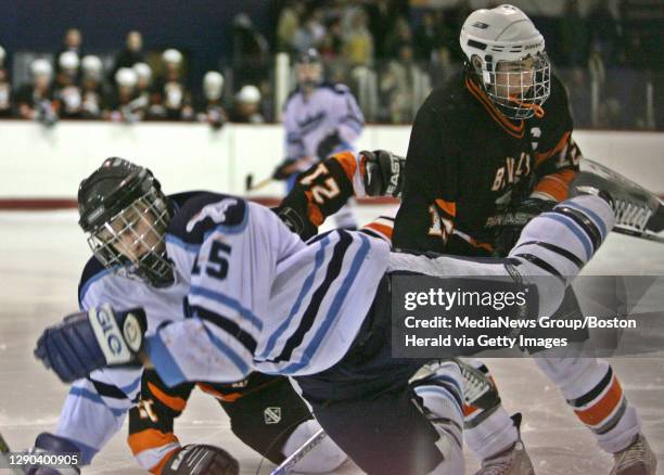 Peabody's Josh Shalin is knocked over by Beverly's Dennis Silvio as peabody HS takes on Beverly wed night at McVann-O`Keefe memorial rink in Peabody