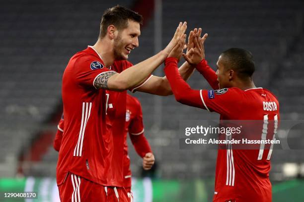 Niklas Süle of FC Bayern München celebrates scoring the opening goal with his team mate Douglas Costa during the UEFA Champions League Group A stage...