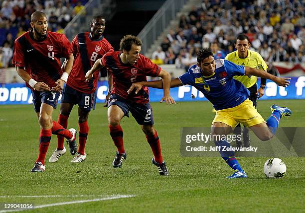 Oguchi Onyewu, Maurice Edu and Steve Cherundolo of the United States chase Jefferson Montero of Ecuador during their match at Red Bull Arena on...