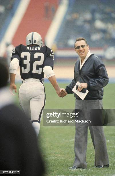 Playoffs: Los Angeles Raiders owner Al Davis shaking hands with Marcus Allen before game vs Seattle Seahawks at Los Angeles Memorial Coliseum. Los...