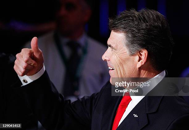 Republican presidential candidate and incumbent Texas Gov. Rick Perry gestures prior to the start of a presidential debate hosted by Bloomberg and...