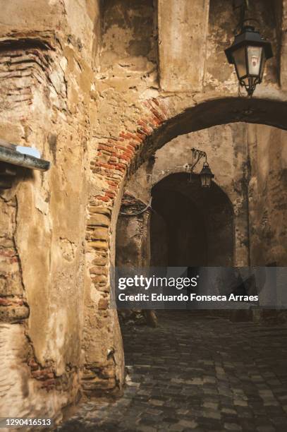 arch and narrow alleys of the medieval town of sighișoara - mures stock pictures, royalty-free photos & images