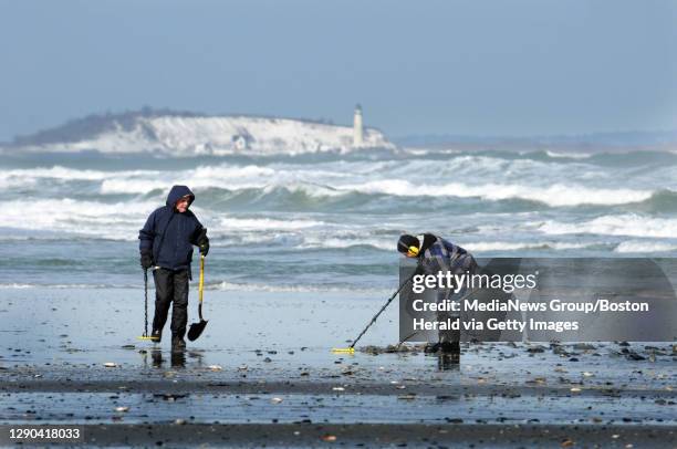 ( - Treasure Hunters use metal detectors to scan the storm churned beach at Nantasket looking for lost objects- Boston Herald Staff Photo by Jim...