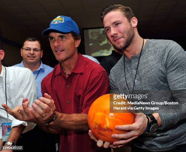 Doug Flutie, left, and New England Patriots' Julian Edelman pose for a photograph during the 10th annual Flutie Bowl at King's in Dedham on Monday,...