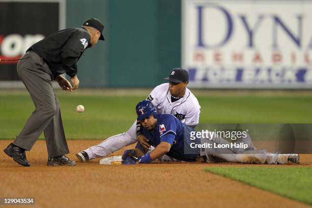 Yorvit Torrealba of the Texas Rangers knocks the ball out of the glove of Ramon Santiago of the Detroit Tigers at second base in the eighth inning of...