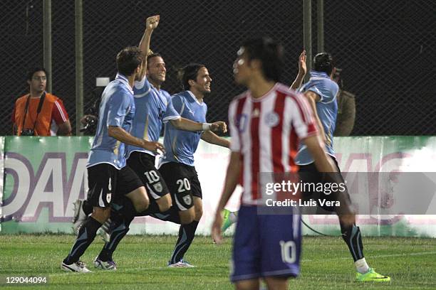 Diego Forlan Sebastian Eguren and Alvaro Gonzalez of Uruguay celebrates a scored in action during as part of the first round of the South American...