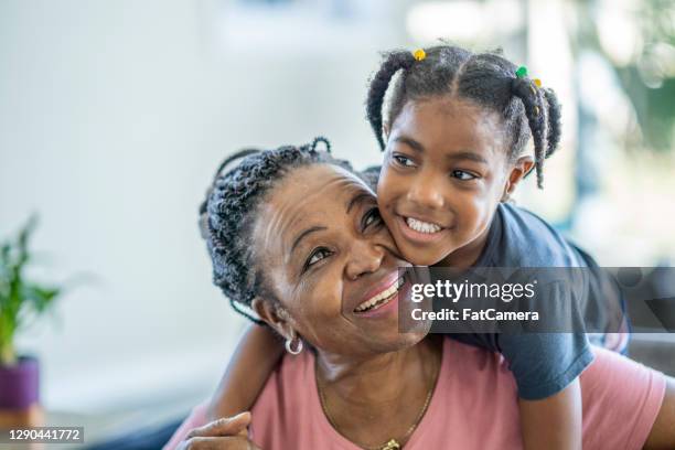 african american grandmother with her granddaughter - african american grandmother stock pictures, royalty-free photos & images