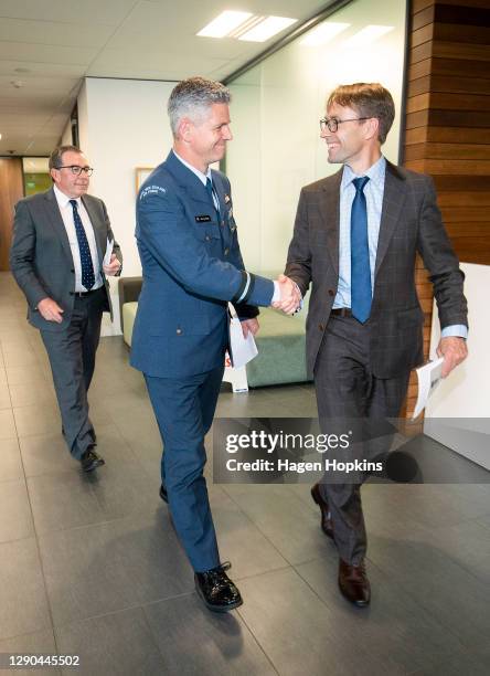 Head of Managed Isolation and Quarantine, Air Commodore Darryn Webb, and Director-General of Health Dr Ashley Bloomfield shake hands as they make and...