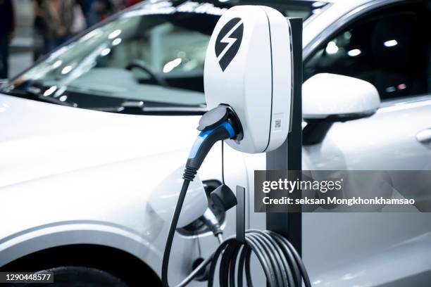electric car in charging - electricity stockfoto's en -beelden