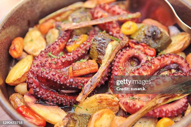 close up of ready-to-eat traditional dalmatian peka, baked octopus with potatoes and vegetables served in pan. - croatia food stock pictures, royalty-free photos & images