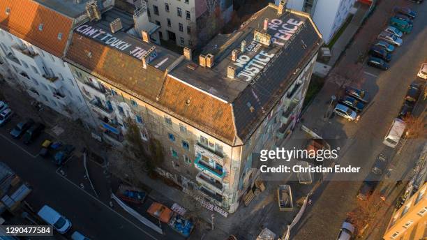 In this aerial view the words: "No justice, no peace" and "Can´t touch this!" are painted in large letters on the roof of the Liebigstrasse 34, also...