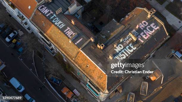 In this aerial view the words: "No justice, no peace" and "Can´t touch this!" are painted in large letters on the roof of the Liebigstrasse 34, also...