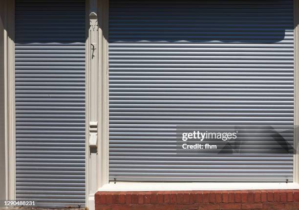 blinds of a closed shop - facade blinds stock pictures, royalty-free photos & images