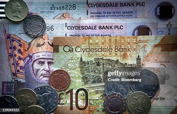 Scottish pound notes, issued by Clydesdale Bank, are seen with U.K. Coins in this arranged photograph in Edinburgh, Scotland, on Tuesday, Oct. 11,...