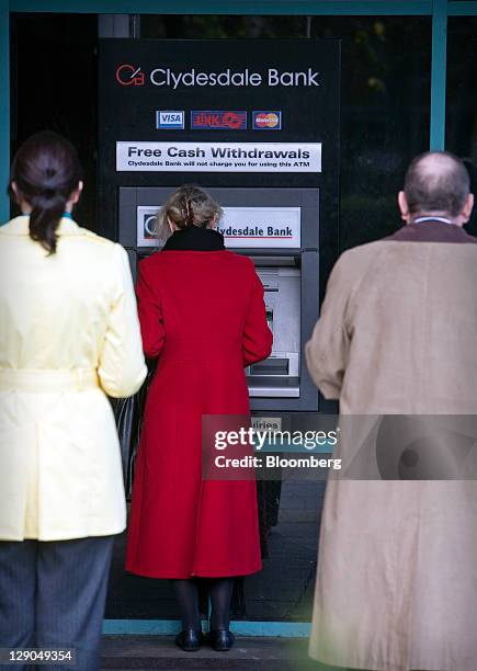 Customers use an automated teller machine outside a Clydesdale Bank branch in Edinburgh, Scotland, on Tuesday, Oct. 11, 2011. Sun Capital, backed by...