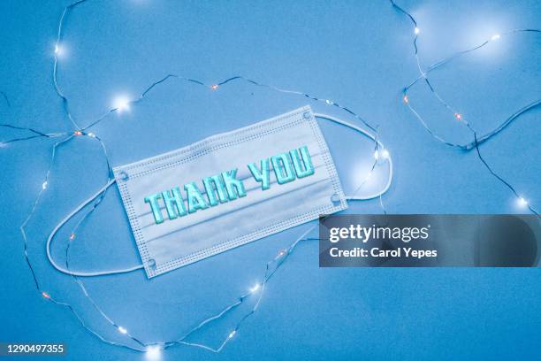 thank you message in surgical mask.blue background - medical thank you imagens e fotografias de stock