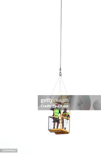 Construction workers on a nearby property take photos of the WACA from crane during day two of the Sheffield Shield match between the Western...