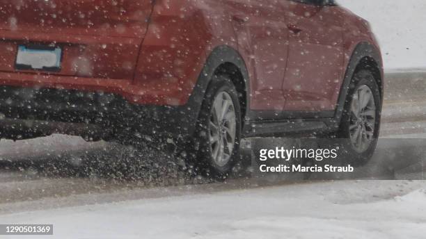 red car driving on an icy snowy road - slippery stock pictures, royalty-free photos & images