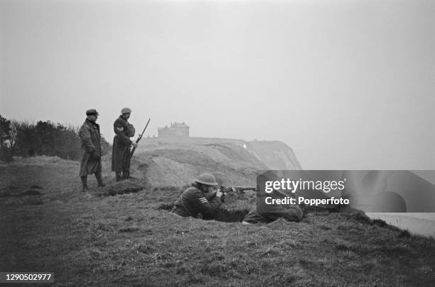 Members of the Home Guard, supporting the British Army on patrol duty, man a defensive fighting position atop the White Cliffs of Dover between the...