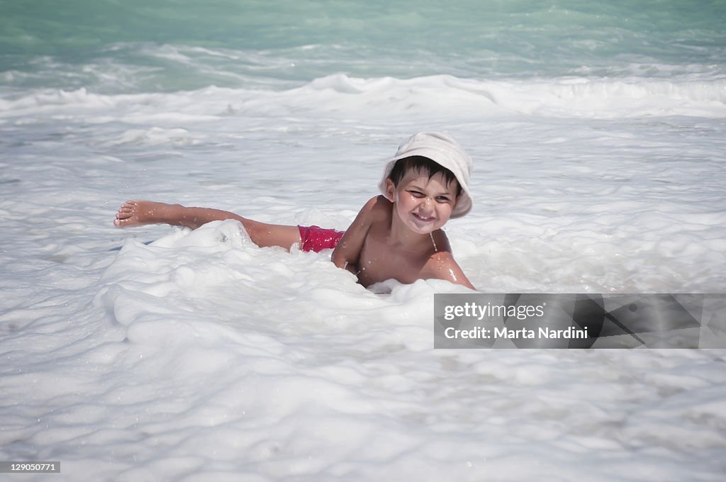 Child playing in surf water n beach