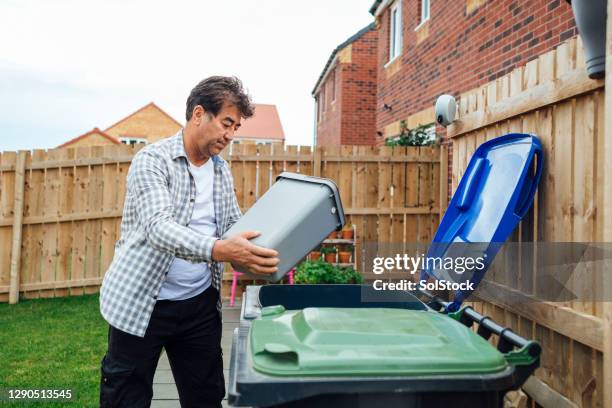 disposing of recycling - wheelie bin stock pictures, royalty-free photos & images