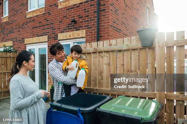 helping out with the recycling - wheelie bin stock pictures, royalty-free photos & images