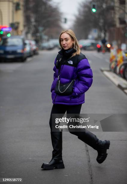 Sonia Lyson is seen wearing black boots Zara, Prada bag, two tone puffer down feather jacket The North Face in purple and black, Lululemon leggins on...