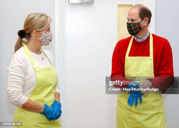 Sophie Countess of Wessex and Prince Edward, Earl of Wessex put on aprons and gloves as they help prepare Christmas dinners for local families during...