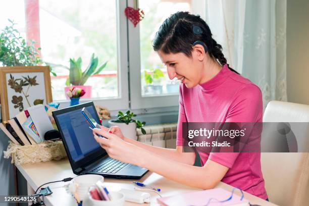 woman shopping online with laptop, smart phone and credit card - hearing loss at work stock pictures, royalty-free photos & images