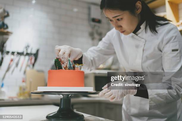 asian girl making cake in studio - pastry chef stock pictures, royalty-free photos & images