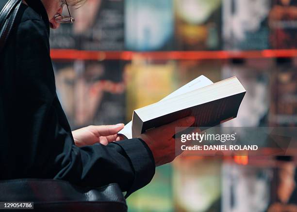 A woman reads a book at the 63rd Frankfu, Nachrichtenfoto