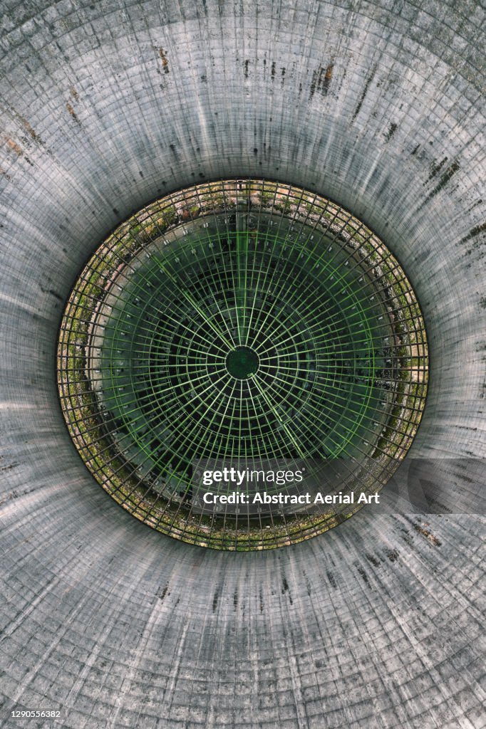 Aerial shot looking down an abandoned smoke stack at Willington Power Station, Derbyshire, England, United Kingdom