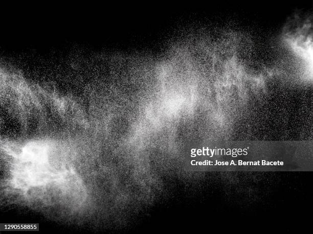 full frame of the textures formed  by the water jets to pressure with drops floating in the air of color white on a black background - fog texture stock-fotos und bilder