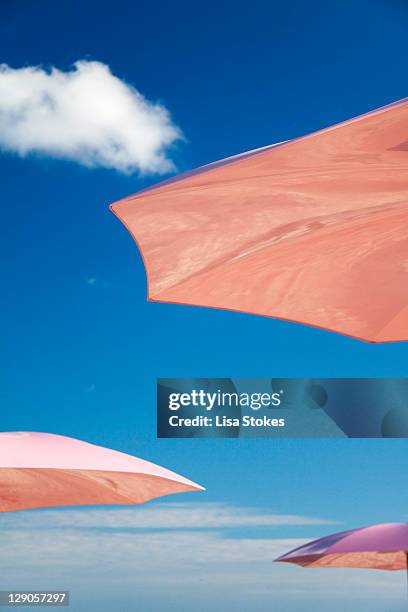 pink umbrellas - beach umbrella stock pictures, royalty-free photos & images