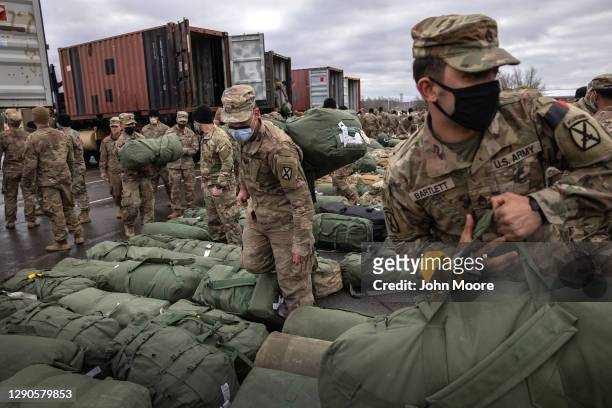 Army soldiers retrieve their duffel bags after they returned home from a 9-month deployment to Afghanistan on December 10, 2020 at Fort Drum, New...