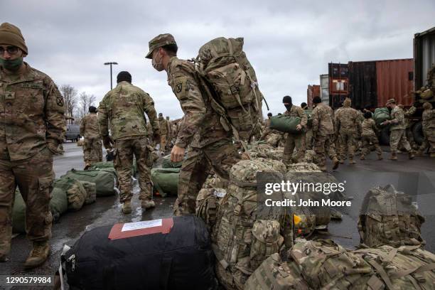 Army soldiers retrieve their duffel bags after they returned home from a 9-month deployment to Afghanistan on December 10, 2020 at Fort Drum, New...