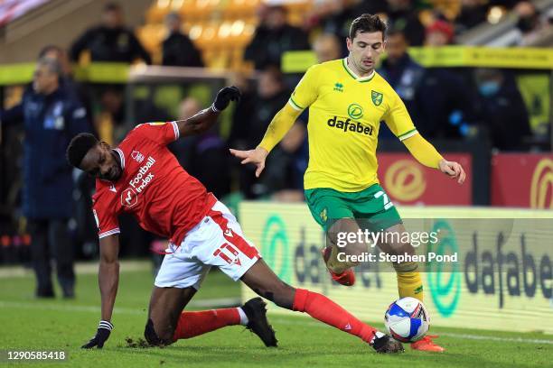Kenny McClean of Norwich City and Sammy Ameobi of Nottingham Forest compete for the ball during the Sky Bet Championship match between Norwich City...