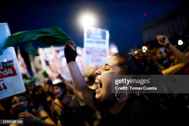 Pro-choice activist shouts slogans outside the National Congress as Deputies vote on a bill to legalize abortion on December 10, 2020 in Buenos...